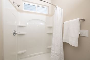 Soaker tub with shower surround and curved rod